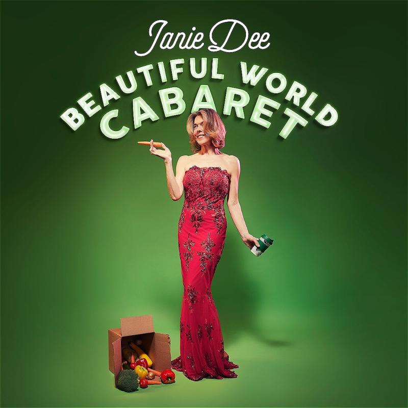 Woman in an elegant red sequined gown with floral patterns, holding a coffee cup and a carrot held as a cigarette. A box of assorted vegetables is at her side. Above her are the neon-style words "Janie Dee Beautiful World Cabaret" against a green background.