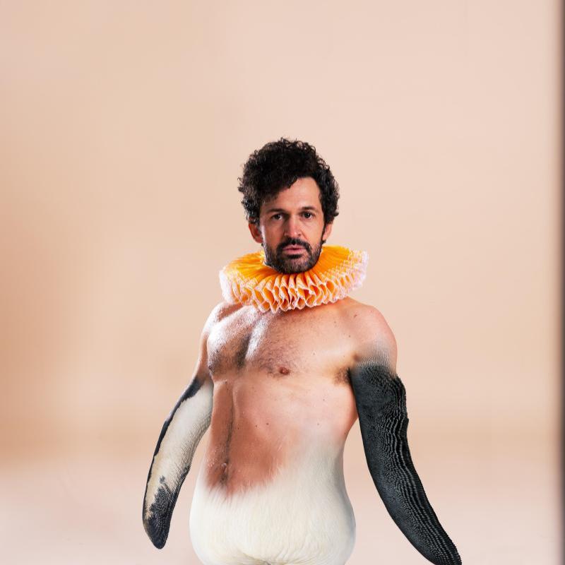 Garry as a half man/half penguin with a clown collar on.