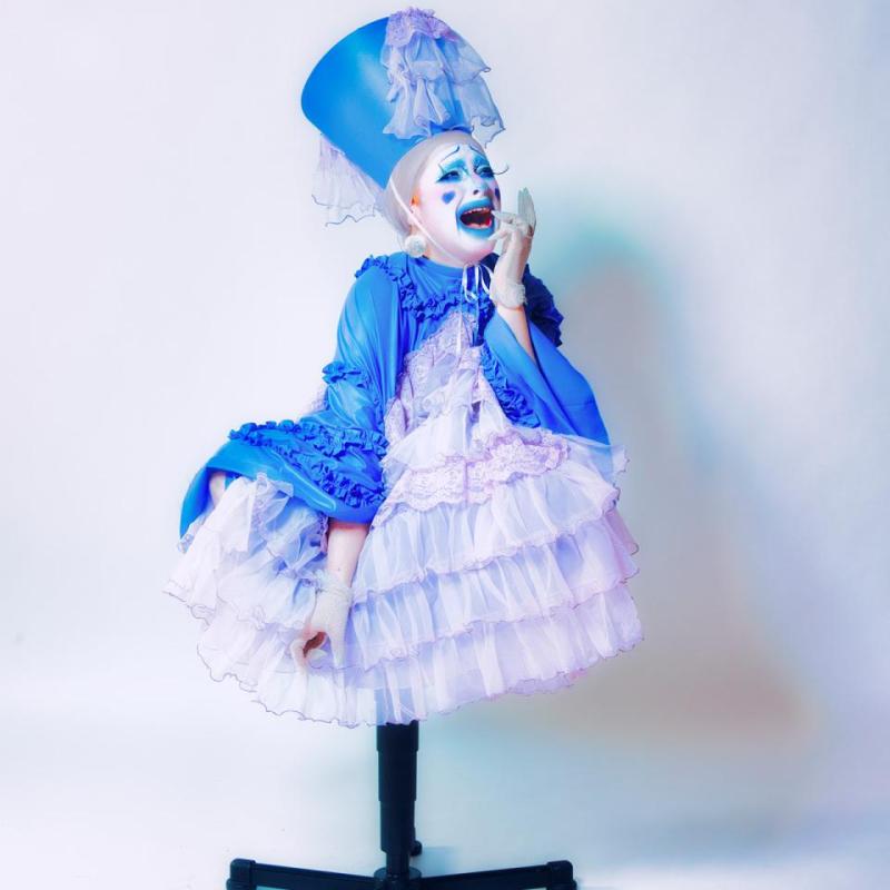 Image of Cabbage The Clown, performer, sitting atop a chair