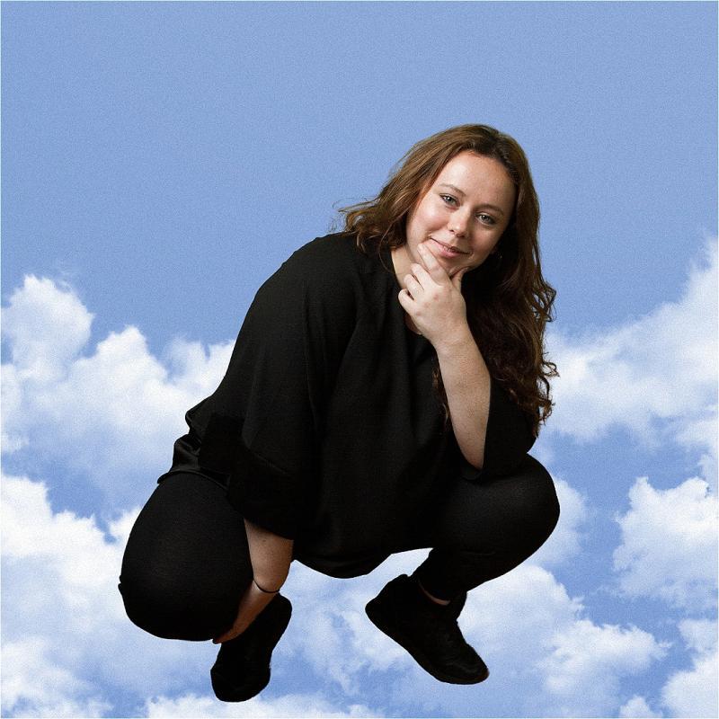 Amy Anette squatting in the clouds.