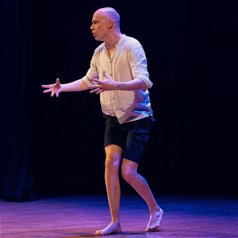 Jordan walking on stage - the light is purple
