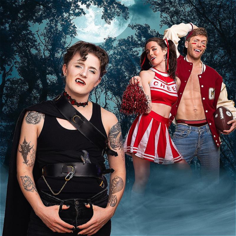 Count Dykula stands in front of two cheerleading humans.