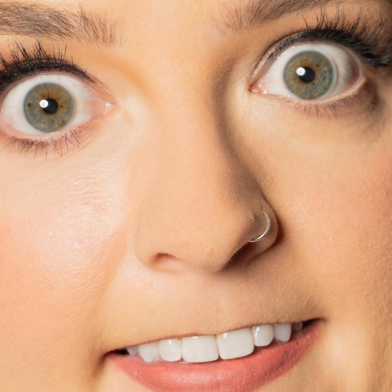 Extreme zoom in of the performer's face, showing her eyes, nose, and mouth