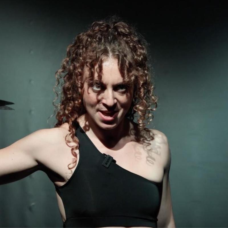 Woman holding scissors angrily.