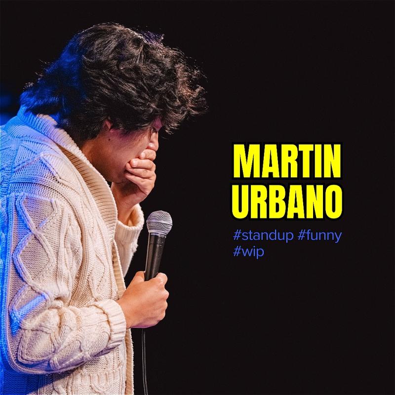 The comic covers his mouth with one hand, the other holds a microphone. To the right is the show name.