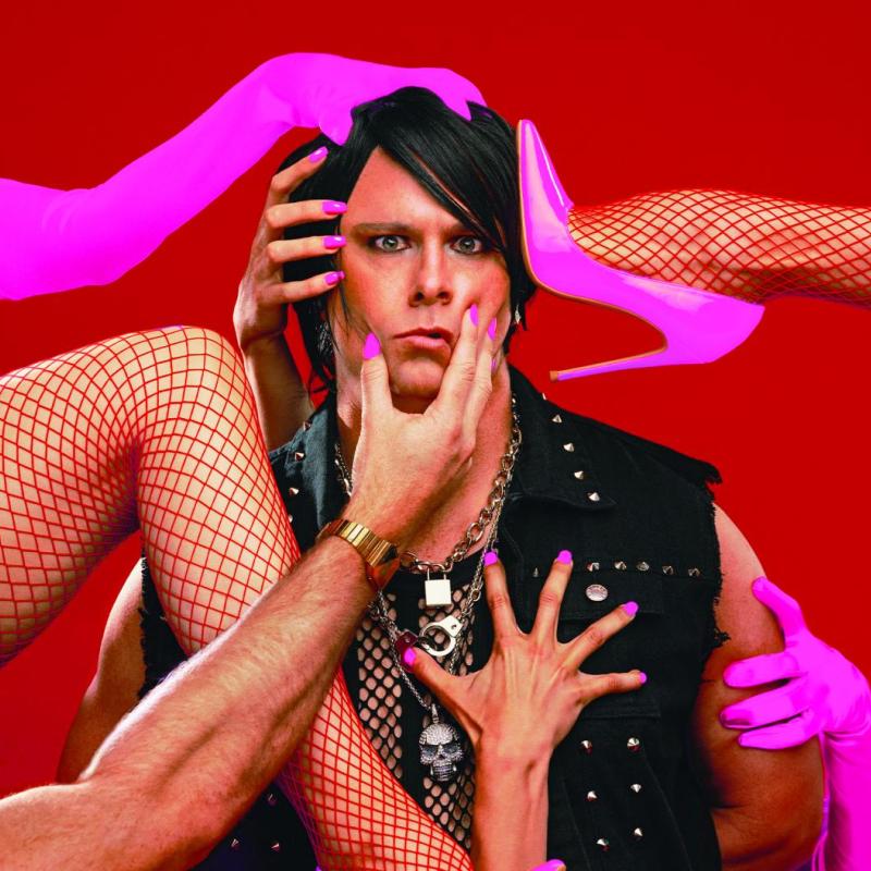 A magician in the centre of the image surrounded by legs in fishnet tights and pink stilettos, and arms with long pink gloves