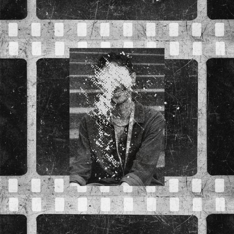 old film with a person on it with their face scratched out