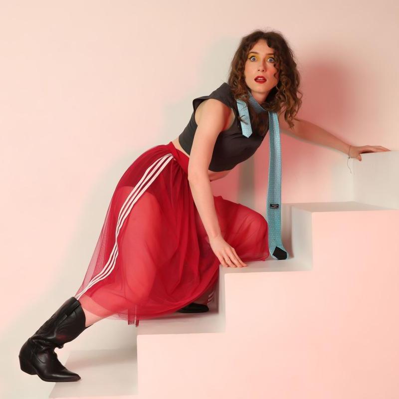 Photo of Holly climbing a white staircase and looking apprehensive.