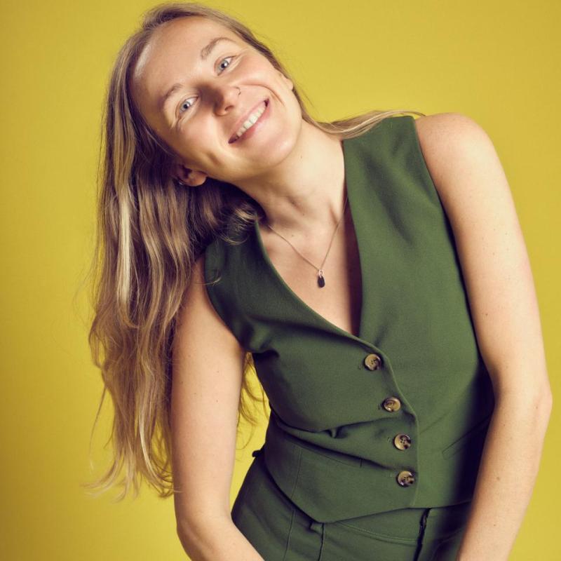 Courtney leaning and smiling at the camera