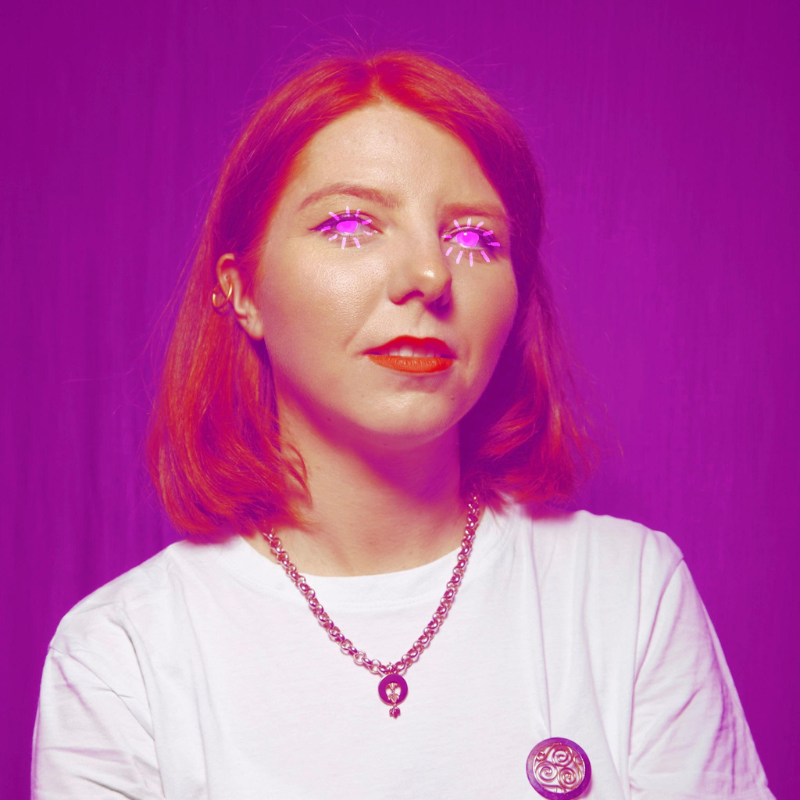 A purple toned image of Marty with their eyes glowing pink neon.