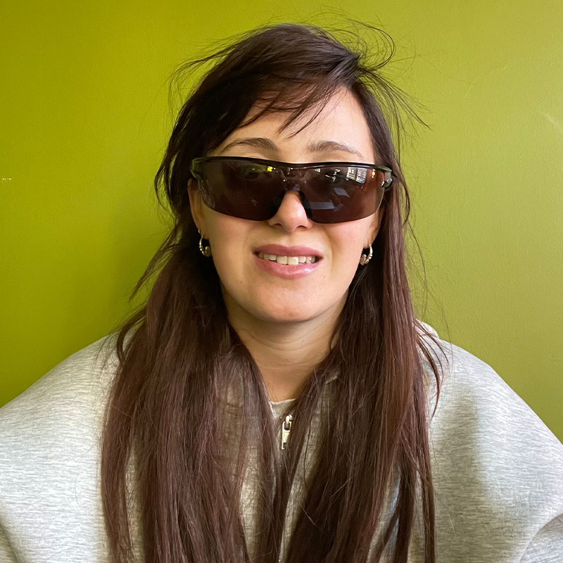 Photo of performer wearing sunglasses and a hoodie.