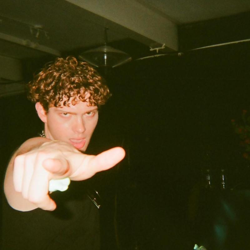 Photo of a person pointing their finger directly towards the viewer.