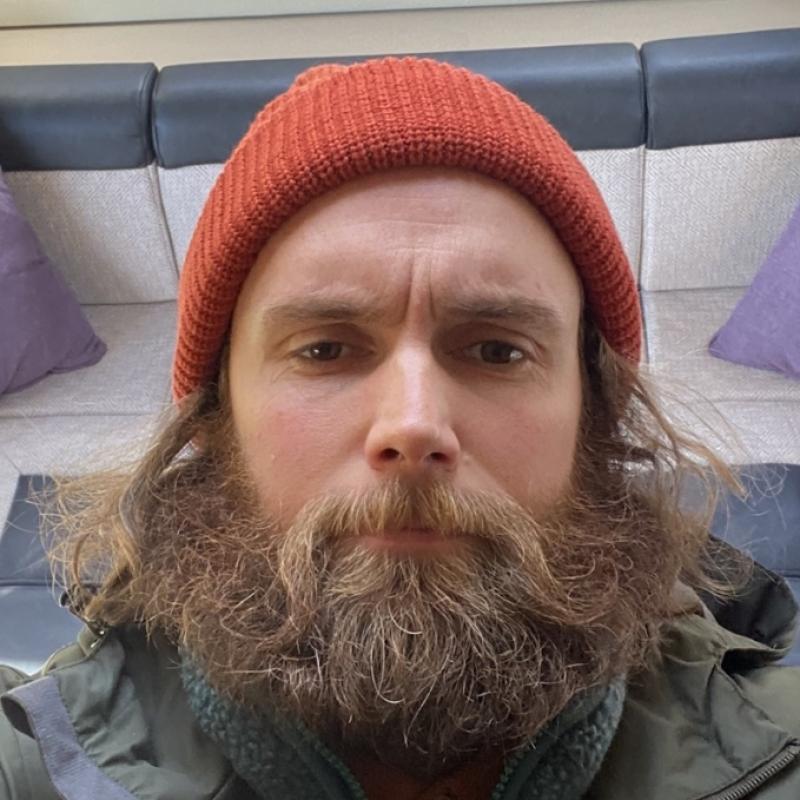 Selfie of Rob in an orange beanie.