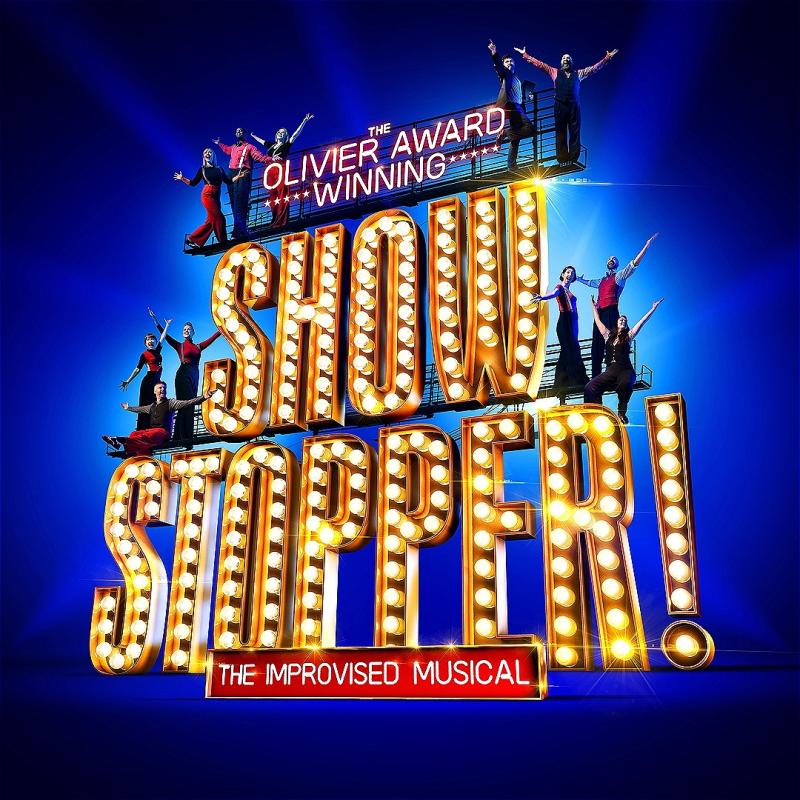 The words 'The Olivier Award Winning... SHOWSTOPPER!' in big theatrical lights with people standing on and around the giant words with their hands aloft.