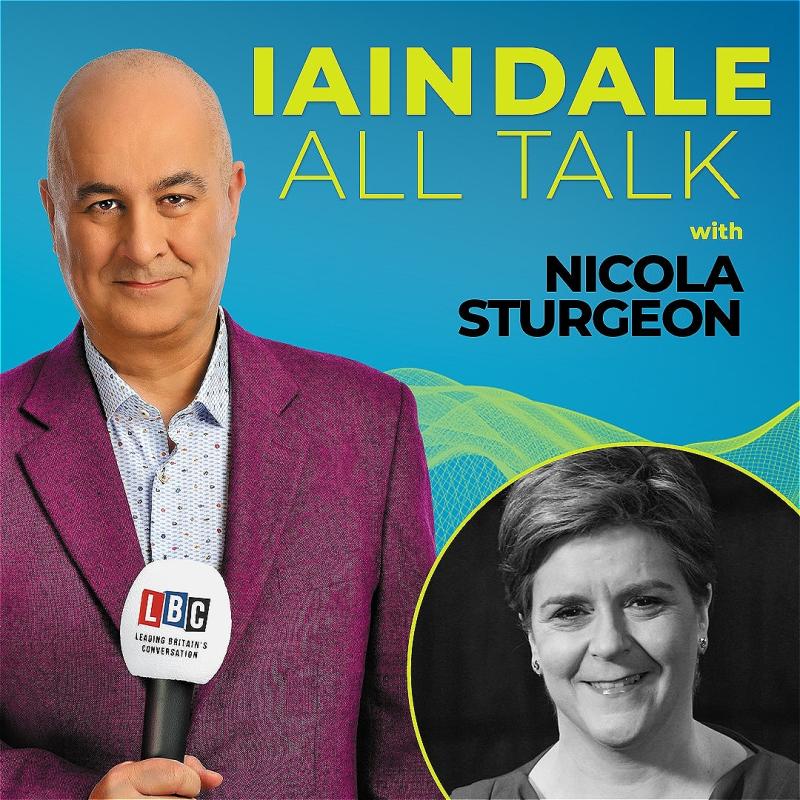 Host Iain Dale stares straight ahead with an LBC microphone wearing a purple blazer before a blue background. A black and white photo of the guest in the bottom right corner.