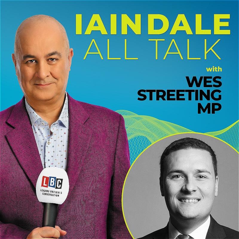 Host Iain Dale stares straight ahead with an LBC microphone wearing a purple blazer before a blue background. A black and white photo of the guest in the bottom right corner.