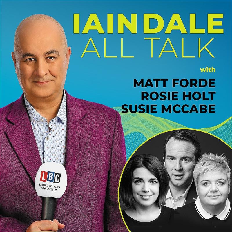 Host Iain Dale stares straight ahead with an LBC microphone wearing a purple blazer before a blue background. A black and white photo of the guests in the bottom right corner.