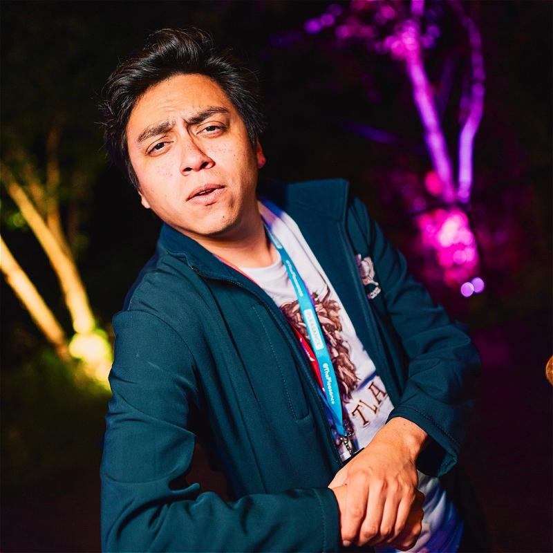 Martin looks inquisitively into the camera, leaning against a railing casually with his elbow. He's wearing a Pleasance lanyard, probably thinking we wouldn't notice one is missing.