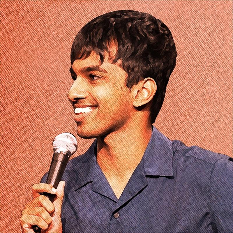 Tarang is holding a mic up to their mouth and smiling. Their blue top contrasts with a salmon background. The image is grainy, but in a stylised way.