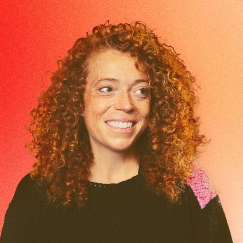 Photo of Michelle Wolf, smiling.