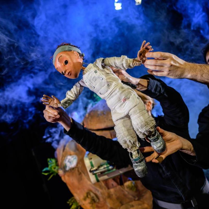 Puppet floating through space with a Tiny Planet behind