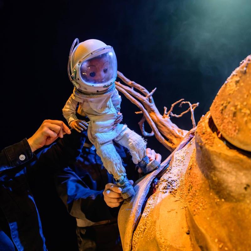 Space person standing on Tiny Planet