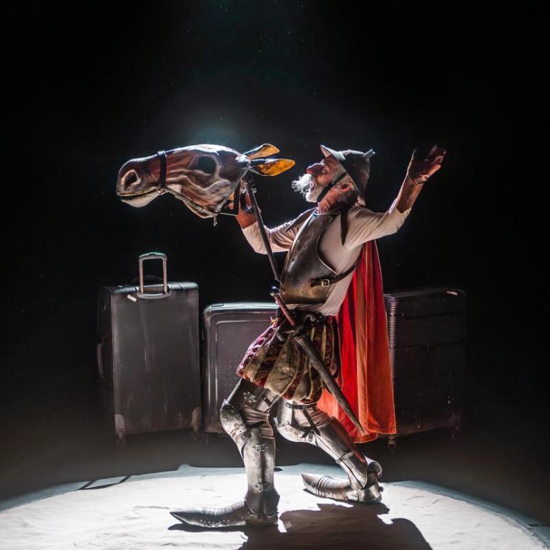 Don Quixote, backlit, with the head of a puppet horse