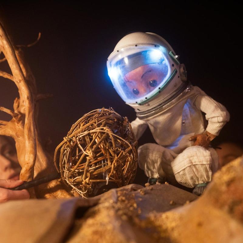 Space Person Looking at a Tumbleweed