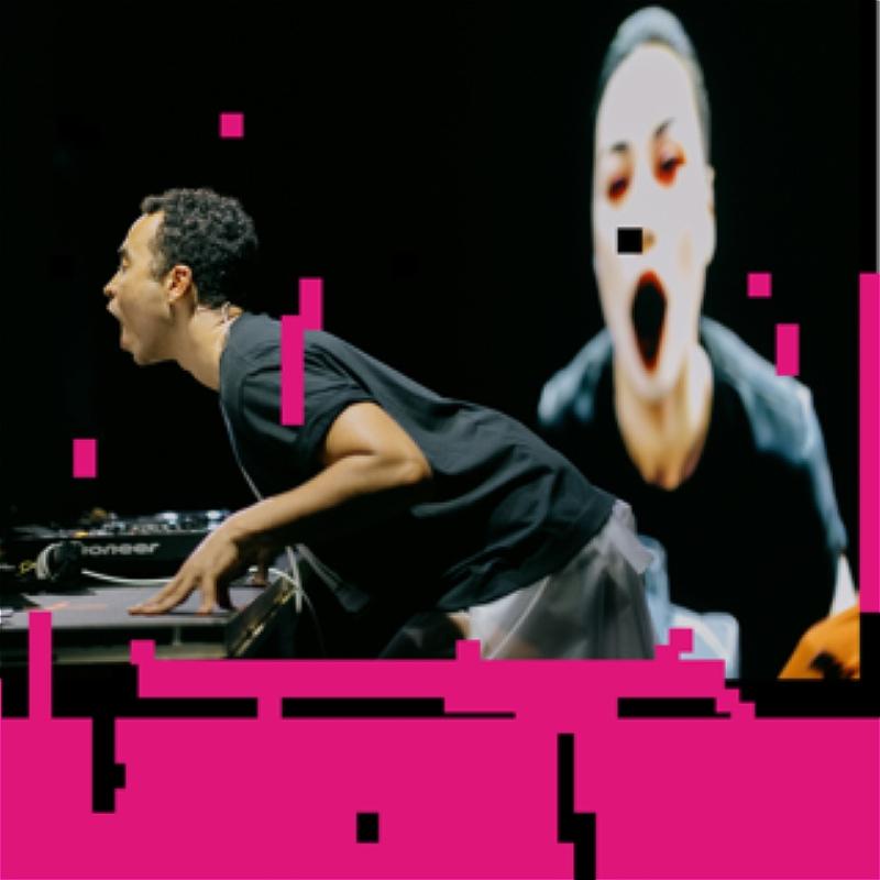 a picture of someone learning over a tech desk, the image is pixelated and pink pixels cover a lot of the image.