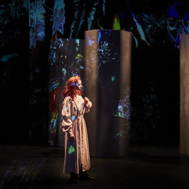 Image of a girl walking through a forest