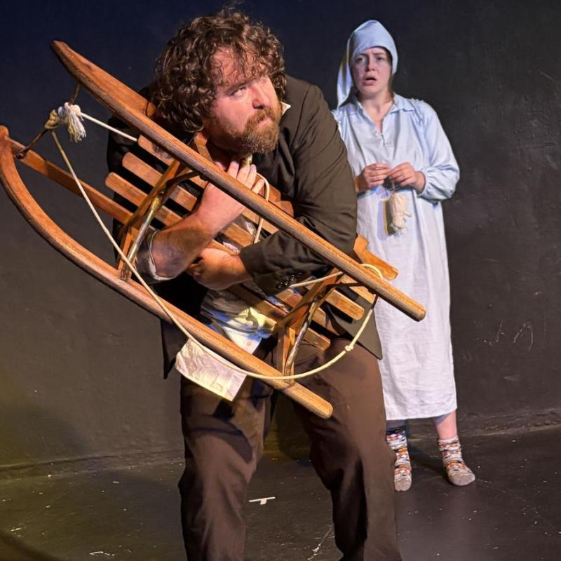 A hunch-backed servant clings onto his sledge fearfully, while a victorian child in powder blue night clothes looks on.