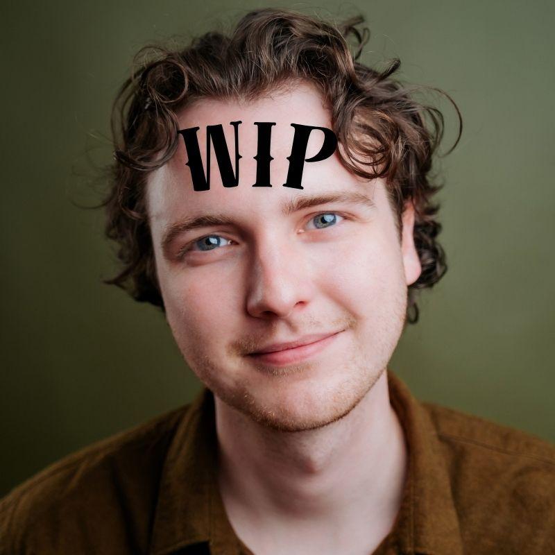 A headshot of the performer with the WIP printed across their forehead.