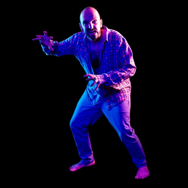 A man in a fighting stance with claw hands.